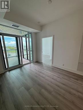 Toronto (Clairlea-Birchmount) condo for rent - A room with wooden flooring and sliding glass doors.