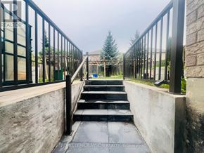 Whitby (Rolling Acres) apartment for rent - A staircase with a metal railing leads to a building.