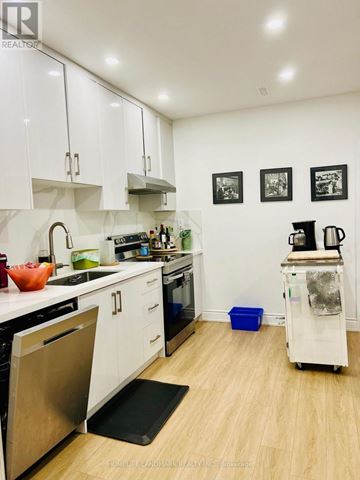 Newmarket (Glenway Estates) apartment for rent - A kitchen with white cabinets and a wooden floor.