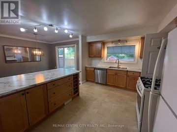 London North (North J) apartment for rent - A kitchen with wooden cabinets and a marble countertop.