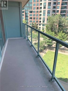 Toronto (Willowdale West) condo for rent - A balcony with a metal railing overlooking a green lawn and a building.