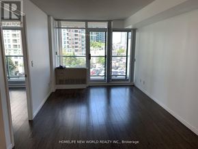 Toronto (Willowdale West) condo for rent - A room with wooden floors and a view of the city through the windows.