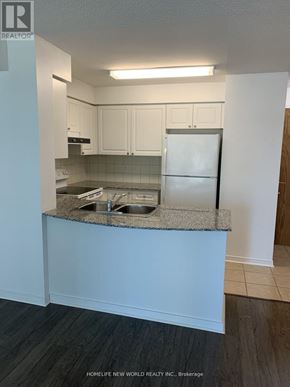 Toronto (Willowdale West) condo for rent - A kitchen with white cabinets and a granite countertop.