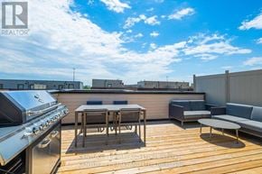 Pickering (Village East) townhouse for rent - A rooftop patio with a grill and seating area.