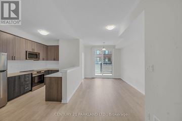 Pickering (Village East) townhouse for rent - A spacious kitchen with dark wood cabinets and stainless steel appliances.