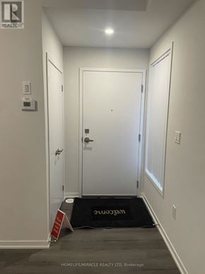 Vaughan (Vaughan Corporate Centre) townhouse for rent - A hallway with a brokerage sign on the floor.