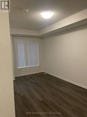 Vaughan (Vaughan Corporate Centre) townhouse for rent - A room with wooden flooring and a window with blinds.