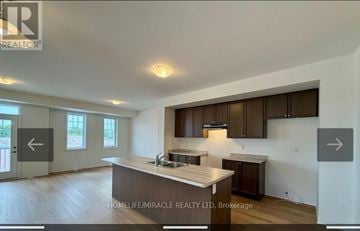 Welland (Dain City) townhouse for rent - A real estate listing image of a kitchen with wooden cabinets and a countertop.
