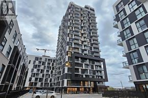 Oakville (Jm Joshua Meadows) condo for rent - A tall residential building with a car parked in front.