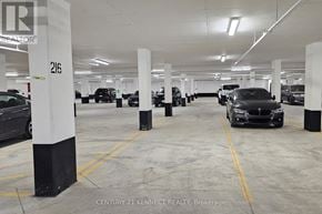 Oakville (Jm Joshua Meadows) condo for rent - A parking garage with cars parked in it.