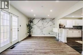 Caledonia apartment for rent - A spacious kitchen with a marble backsplash and wooden flooring.