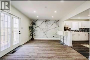 Caledonia apartment for rent - A spacious kitchen with a marble backsplash and wooden flooring.
