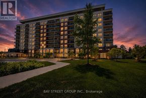 London North (North R) condo for rent - A modern apartment building with a well-maintained lawn in front.