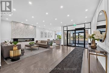 London North (North R) condo for rent - A modern living room with a grey sofa set and a fireplace.