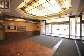 Toronto (University) apartment for rent - A hallway with a glass wall and a carpeted floor.