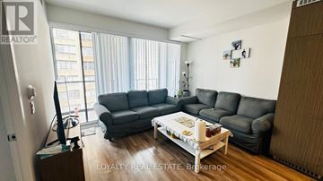 Toronto (Bay Street Corridor) condo for rent - A living room with a grey couch and a coffee table.