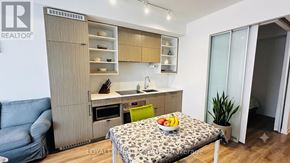 Toronto (Bay Street Corridor) condo for rent - A modern kitchen with a dining table and chairs.