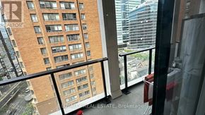Toronto (Bay Street Corridor) condo for rent - A balcony with a glass railing and a view of a cityscape.