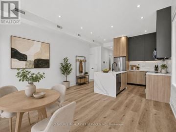 Toronto (Clanton Park) multi-family for rent - A modern kitchen with a dining table and chairs.