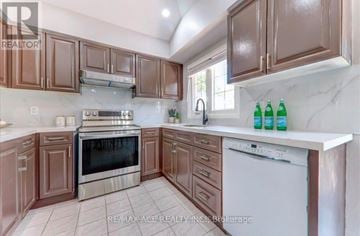 Pickering (Amberlea) apartment for rent - A kitchen with brown cabinets and a white dishwasher.
