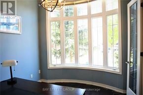 Richmond Hill (Oak Ridges) apartment for rent - A room with a large window and a chandelier.
