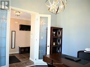 Richmond Hill (Oak Ridges) apartment for rent - A living room with a television, a bookcase, and a chandelier.