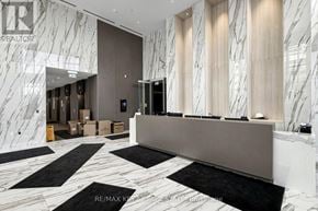 Mississauga (City Centre) condo for rent - A reception area with a marble floor and a white reception desk.