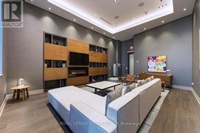 Toronto (Waterfront Communities) condo for rent - A modern bedroom with a large bed and a TV mounted on the wall.