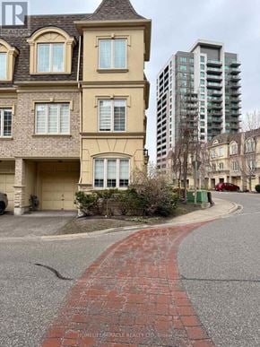 Pickering (Bay Ridges) townhouse for rent - A brick pathway leads to a building with a sign that reads "HOMELIFETRADIANCE REALTY LTD.".