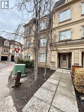 Pickering (Bay Ridges) townhouse for rent - A street view of a building with a sign in front of it.
