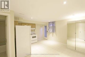 Toronto (Dovercourt-Wallace Emerson-Junction) apartment for rent - A white refrigerator is in a kitchen with a white floor.