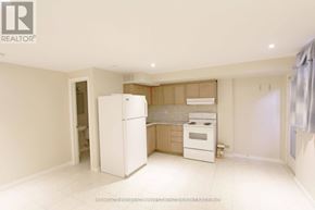 Toronto (Dovercourt-Wallace Emerson-Junction) apartment for rent - A white refrigerator in a kitchen with a wooden counter.
