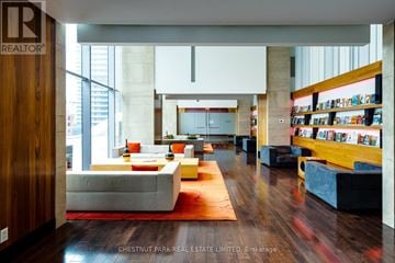 Toronto (Waterfront Communities) condo for rent - A living room with a white couch and a red rug.