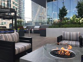 Toronto (Waterfront Communities) condo for rent - A glass table with a fire pit in the middle of it.
