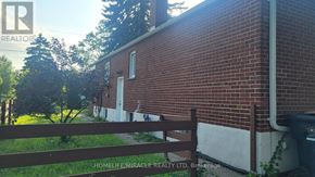 Toronto (West Hill) apartment for rent - A red brick house with a wooden fence in front.