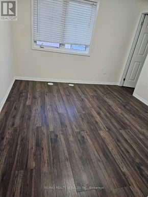 Brampton (Fletcher's West) townhouse for rent - A room with wooden flooring and a window with blinds.