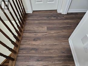 Brampton (Fletcher's West) townhouse for rent - A wooden floor in a hallway with a white door.