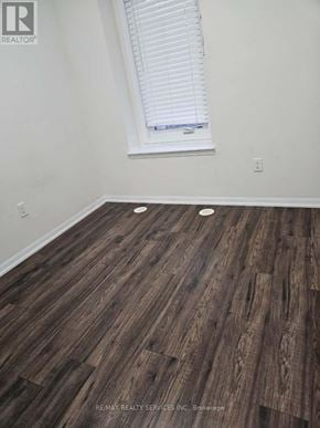 Brampton (Fletcher's West) townhouse for rent - A room with a window and wooden flooring.