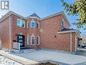 Mississauga (Erin Mills) apartment for rent - A red brick house with a black door and windows.