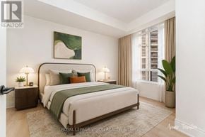Toronto (West Humber-Clairville) condo for rent - A bedroom with a large bed and a painting on the wall.