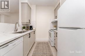 Toronto (West Humber-Clairville) condo for rent - A white kitchen with a sink and a refrigerator.
