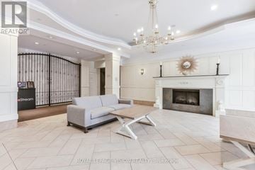 Toronto (West Humber-Clairville) condo for rent - A living room with a grey sofa and a chandelier.