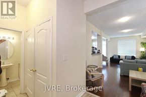 Mississauga (Churchill Meadows) apartment for rent - A living room with a couch, chair, and a dining table.
