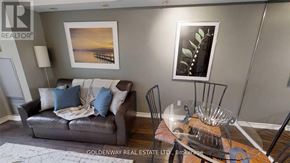 Toronto (Bay Street Corridor) condo for rent - A living room with a brown leather couch and a glass table.