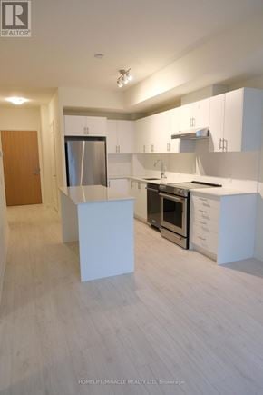 Vaughan (Vellore Village) condo for rent - A modern kitchen with white cabinets and a wooden floor.