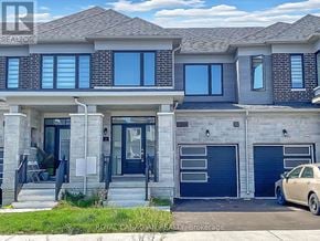 Barrie townhouse for rent - A two-story house with a car parked in front.