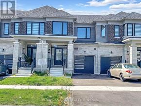 Barrie townhouse for rent - A two-story house with a car parked in front.