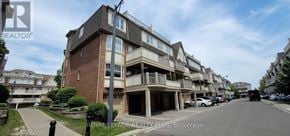 Mississauga (Cooksville) townhouse for rent - A street view of a residential area with apartment buildings.
