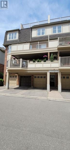 Mississauga (Cooksville) townhouse for rent - A multi-story apartment building with balconies and garages.