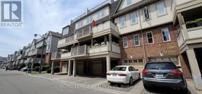 Mississauga (Cooksville) townhouse for rent - A street view of a row of townhouses with cars parked in front.